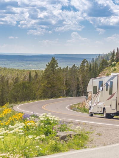 camper-driving-down-road-in-the-beautiful-countrys